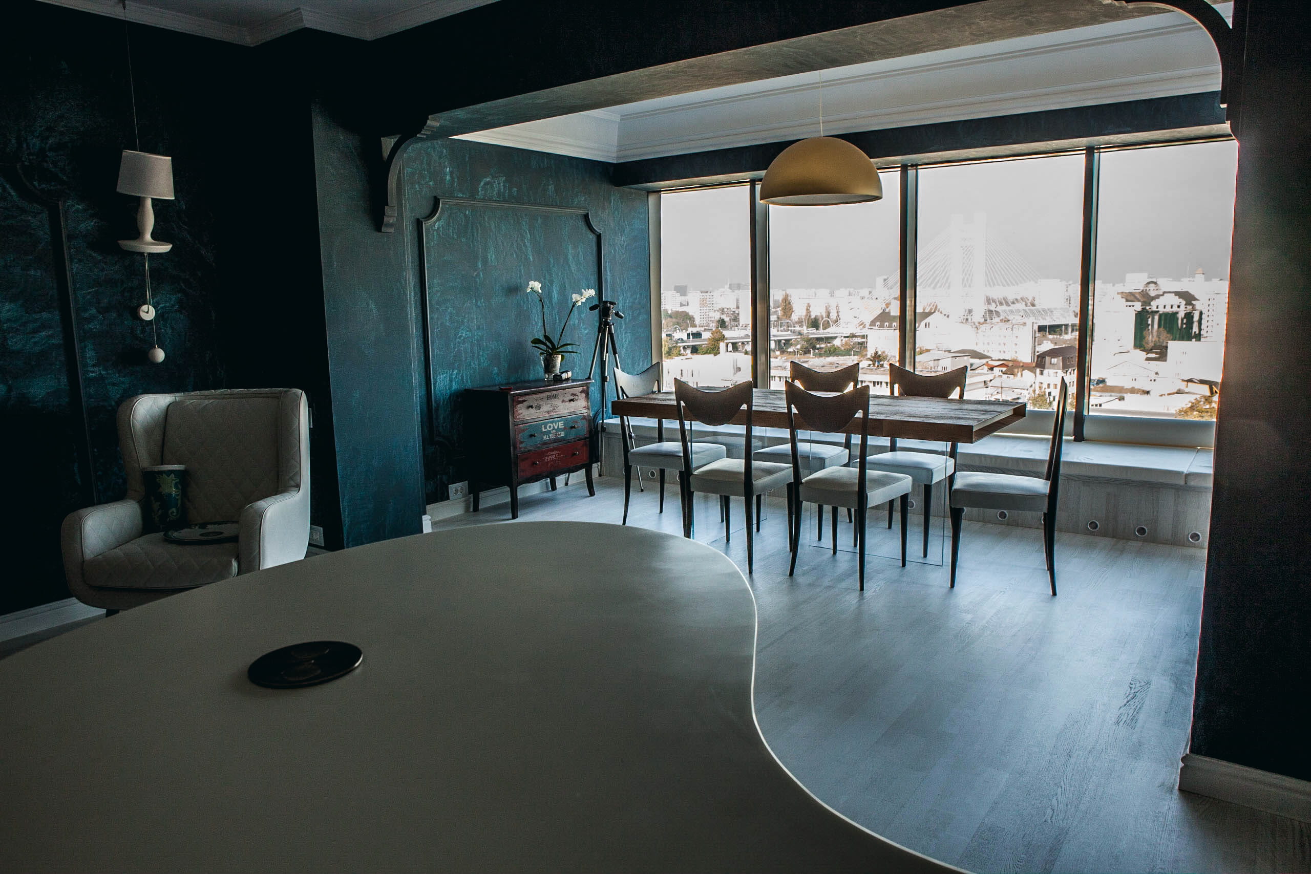 Bucharest Apartment — Curved counter and dining depth